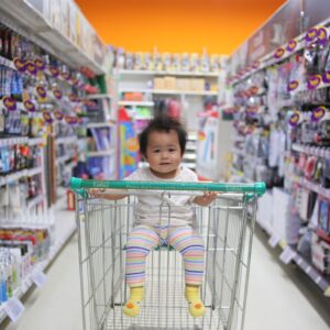 baby on white shopping cart